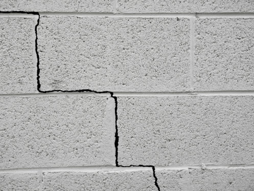 A crack in a cinderblock building due to an earthquake.