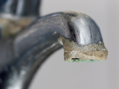 Hard water buildup over time on a faucet